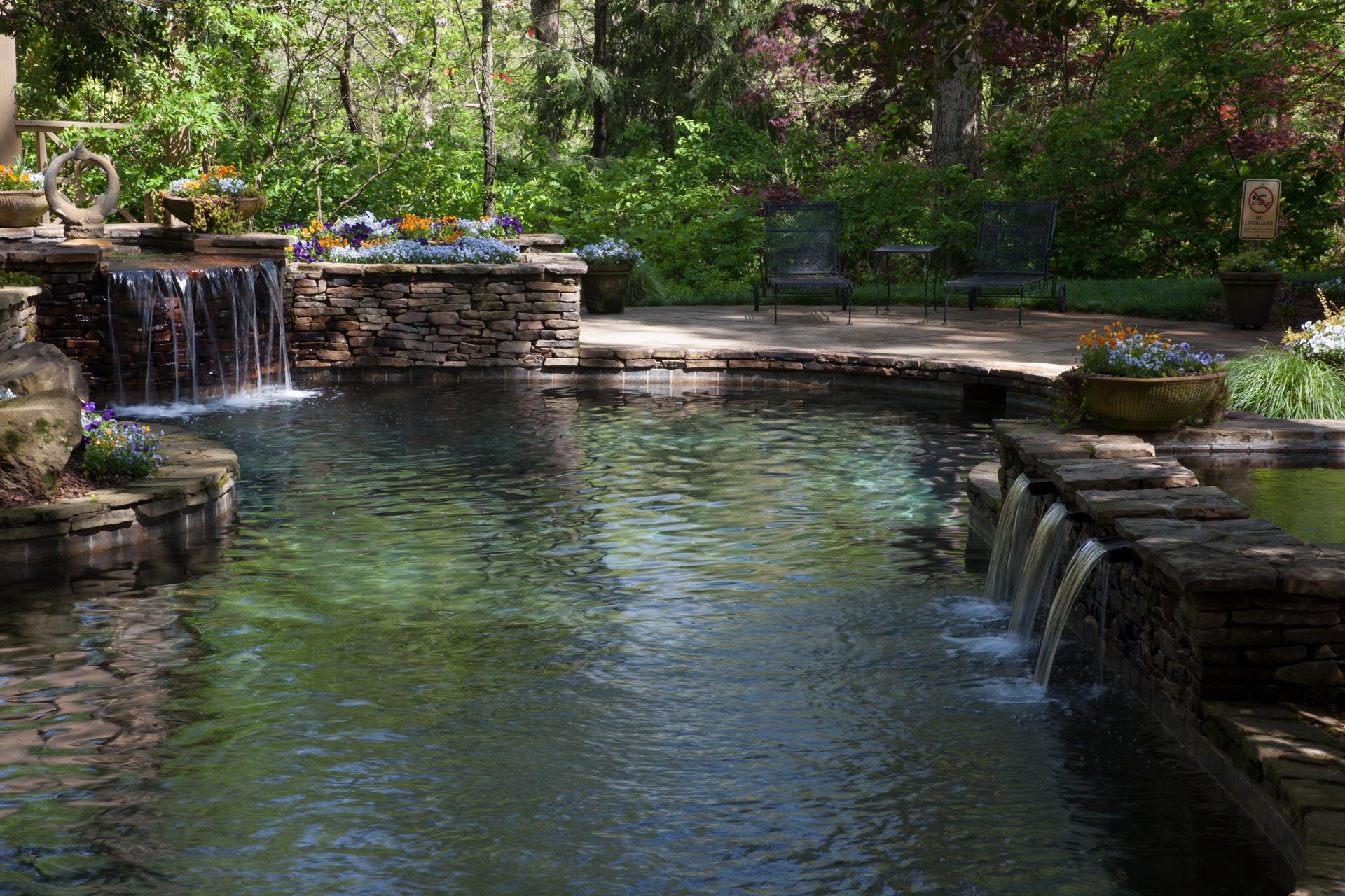 Waterfall Feature Flowing into Serene Garden Pool by NaturesCharm Licensed to Polmenna Pools Waterfall Feature Flowing into Serene Garden Pool by NaturesCharm Licensed to Polmenna Pools